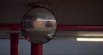 Movie still from “Dazed and Confused” (1993), directed by Richard Linklater – A car is seen in the reflection of a mirror; Extreme Wide shot, Low angle