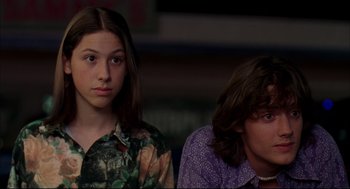 Movie still from “Dazed and Confused” (1993), directed by Richard Linklater – Two young people sitting next to each other in a room; Close Up shot, Low angle