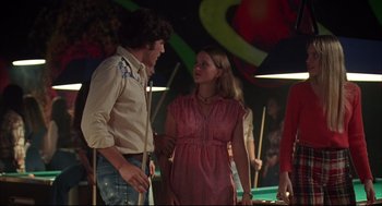 Movie still from “Dazed and Confused” (1993), directed by Richard Linklater – A man and a woman standing next to a pool table; Medium shot, Low angle