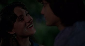 Movie still from “Dazed and Confused” (1993), directed by Richard Linklater – A man and a woman smiling at each other; Close Up shot, Over the shoulder angle