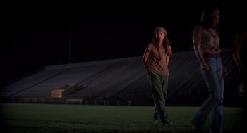 Movie still from “Dazed and Confused” (1993), directed by Richard Linklater – A person standing in a field at night; Wide shot, Low angle