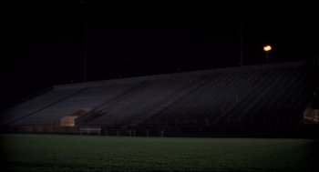Movie still from “Dazed and Confused” (1993), directed by Richard Linklater – An image of an empty stadium at night time; Extreme Wide shot, Low angle