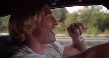 Movie still from “Dazed and Confused” (1993), directed by Richard Linklater – A man sitting in the driver's seat of a car; Close Up shot, Low angle