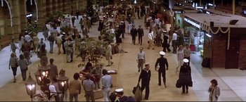 Movie still from “Dead Calm” (1989), directed by Phillip Noyce – A crowd of people walking around a building; Extreme Wide shot, High angle