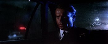 Movie still from “Dead Calm” (1989), directed by Phillip Noyce – A person wearing a suit and tie; Close Up shot, Low angle