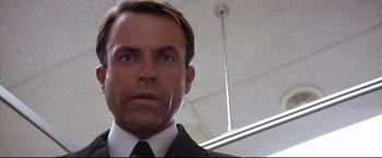Movie still from “Dead Calm” (1989), directed by Phillip Noyce – A person wearing a suit and tie; Close Up shot, Low angle