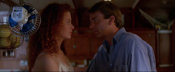 Movie still from “Dead Calm” (1989), directed by Phillip Noyce – A man and a woman standing next to each other in a kitchen; Close Up shot, Low angle
