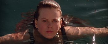 Movie still from “Dead Calm” (1989), directed by Phillip Noyce – A person swimming in a body of water; Close Up shot, Low angle