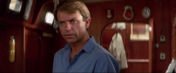 Movie still from “Dead Calm” (1989), directed by Phillip Noyce – A person wearing a blue shirt; Close Up shot, Low angle