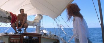 Movie still from “Dead Calm” (1989), directed by Phillip Noyce – A woman standing on the deck of a sail boat in the ocean; Wide shot, Low angle