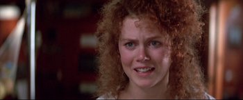 Movie still from “Dead Calm” (1989), directed by Phillip Noyce – A person with curly red hair; Close Up shot, Over the shoulder angle