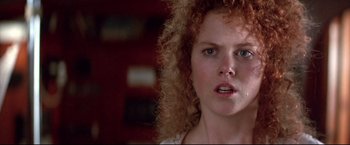 Movie still from “Dead Calm” (1989), directed by Phillip Noyce – A person with curly red hair; Close Up shot, Low angle