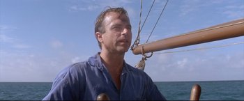 Movie still from “Dead Calm” (1989), directed by Phillip Noyce – A person on a sailboat in the ocean; Close Up shot, Low angle