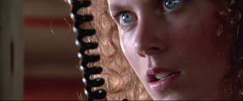 Movie still from “Dead Calm” (1989), directed by Phillip Noyce – A girl's face with a hair brush in her hair; Extreme Close Up shot, Low angle