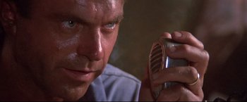 Movie still from “Dead Calm” (1989), directed by Phillip Noyce – A person holding a cell phone; Close Up shot, Low angle