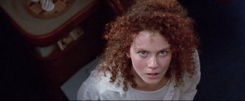 Movie still from “Dead Calm” (1989), directed by Phillip Noyce – A person with curly red hair; Close Up shot, Overhead angle