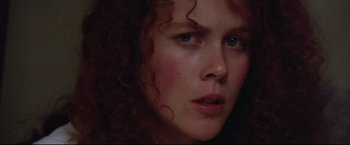 Movie still from “Dead Calm” (1989), directed by Phillip Noyce – A person with curly red hair; Close Up shot, Low angle