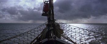 Movie still from “Dead Calm” (1989), directed by Phillip Noyce – A sail boat in the water under a cloudy sky; Extreme Wide shot, High angle