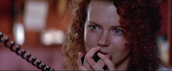 Movie still from “Dead Calm” (1989), directed by Phillip Noyce – A person talking on a cell phone; Close Up shot, Low angle