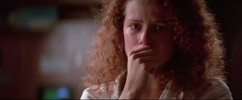 Movie still from “Dead Calm” (1989), directed by Phillip Noyce – A person with curly red hair; Close Up shot, Over the shoulder angle