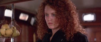 Movie still from “Dead Calm” (1989), directed by Phillip Noyce – A person with curly red hair; Close Up shot, Low angle