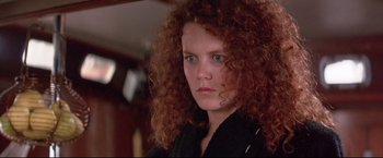 Movie still from “Dead Calm” (1989), directed by Phillip Noyce – A person with curly red hair; Close Up shot, Low angle