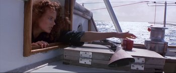 Movie still from “Dead Calm” (1989), directed by Phillip Noyce – A woman in black gloves on a boat in the ocean; Medium shot, Low angle