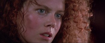 Movie still from “Dead Calm” (1989), directed by Phillip Noyce – A person with curly red hair crying; Close Up shot, Low angle