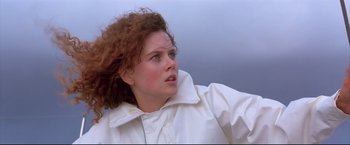 Movie still from “Dead Calm” (1989), directed by Phillip Noyce – A person with curly hair wearing a white jacket; Close Up shot, Low angle