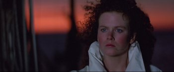 Movie still from “Dead Calm” (1989), directed by Phillip Noyce – A person sitting in front of a window; Close Up shot, Low angle