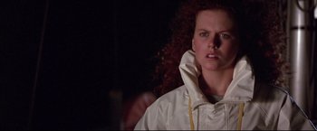 Movie still from “Dead Calm” (1989), directed by Phillip Noyce – A person with curly hair wearing a white jacket; Close Up shot, Low angle