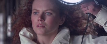 Movie still from “Dead Calm” (1989), directed by Phillip Noyce – A person with curly red hair; Close Up shot, Low angle