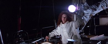 Movie still from “Dead Calm” (1989), directed by Phillip Noyce – A woman standing at the wheel of a sailboat at night; Medium shot, Low angle