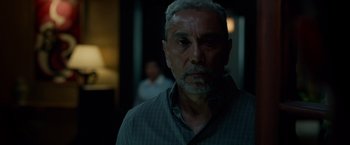 Movie still from “Dead Man Down” (2013), directed by Niels Arden Oplev – An older man with grey hair and a gray beard; Close Up shot, Over the shoulder angle
