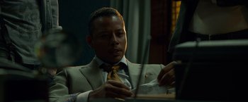 Movie still from “Dead Man Down” (2013), directed by Niels Arden Oplev – A man sitting at a table with a knife in his hand; Close Up shot, Over the shoulder angle