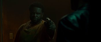 Movie still from “Dead Man Down” (2013), directed by Niels Arden Oplev – A man holding a gun in a dark room; Close Up shot, Low angle