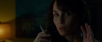 Movie still from “Dead Man Down” (2013), directed by Niels Arden Oplev – A person holding a cigarette; Close Up shot, Over the shoulder angle