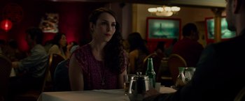 Movie still from “Dead Man Down” (2013), directed by Niels Arden Oplev – A woman sitting at a table with a glass of wine; Close Up shot, Over the shoulder angle