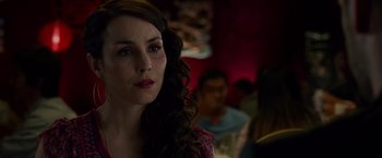 Movie still from “Dead Man Down” (2013), directed by Niels Arden Oplev – A person in a room with other people; Close Up shot, Over the shoulder angle