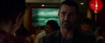 Movie still from “Dead Man Down” (2013), directed by Niels Arden Oplev – A person wearing a suit; Close Up shot, Over the shoulder angle