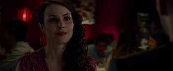 Movie still from “Dead Man Down” (2013), directed by Niels Arden Oplev – A person with long curly hair; Close Up shot, Over the shoulder angle