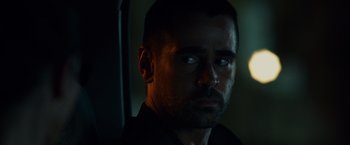 Movie still from “Dead Man Down” (2013), directed by Niels Arden Oplev – A person wearing a black shirt; Close Up shot, Over the shoulder angle