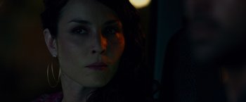 Movie still from “Dead Man Down” (2013), directed by Niels Arden Oplev – A woman's face in the dark; Close Up shot, Over the shoulder angle