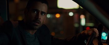 Movie still from “Dead Man Down” (2013), directed by Niels Arden Oplev – A person in a dark room; Close Up shot, Over the shoulder angle