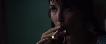 Movie still from “Dead Man Down” (2013), directed by Niels Arden Oplev – A person holding a lit cigarette; Close Up shot, Low angle