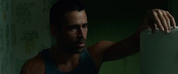 Movie still from “Dead Man Down” (2013), directed by Niels Arden Oplev – A person wearing a tank top; Close Up shot, Low angle
