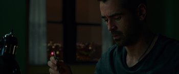 Movie still from “Dead Man Down” (2013), directed by Niels Arden Oplev – A person using a cell phone; Close Up shot, Over the shoulder angle
