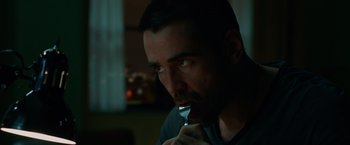 Movie still from “Dead Man Down” (2013), directed by Niels Arden Oplev – A person holding a spoon in his mouth; Close Up shot, Over the shoulder angle