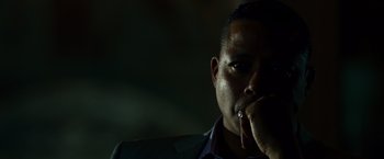 Movie still from “Dead Man Down” (2013), directed by Niels Arden Oplev – A person with his hand to his face; Close Up shot, Low angle