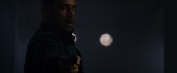 Movie still from “Dead Man Down” (2013), directed by Niels Arden Oplev – A man holding a gun in front of the moon; Close Up shot, Low angle